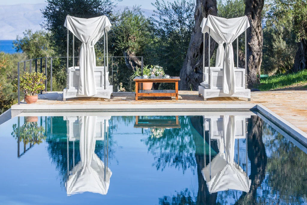 Infinity pool with white garden furniture