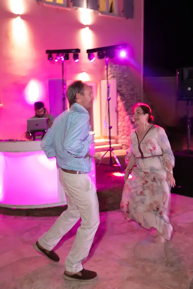 Guests dancing to music with disco lights.