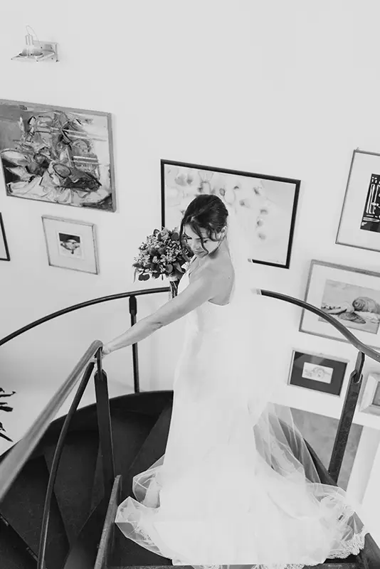 Bride walking down spiral staircase