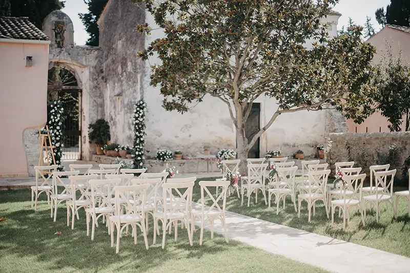 Guest ceremony seating in the garden with a tree