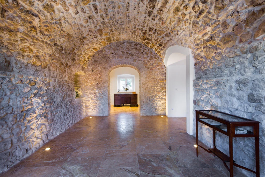 Hallway with stone arch and marble flooring