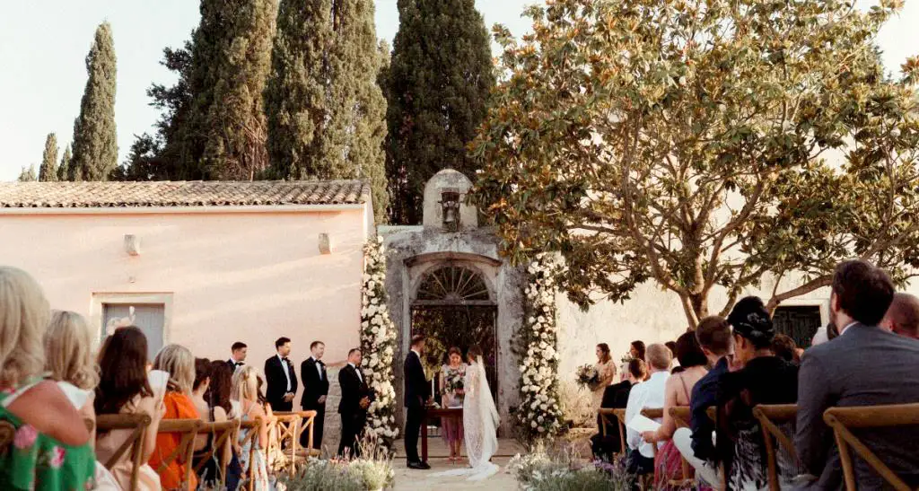 An outdoor wedding being held in the sunshine at the Courti Estate in Corfu.