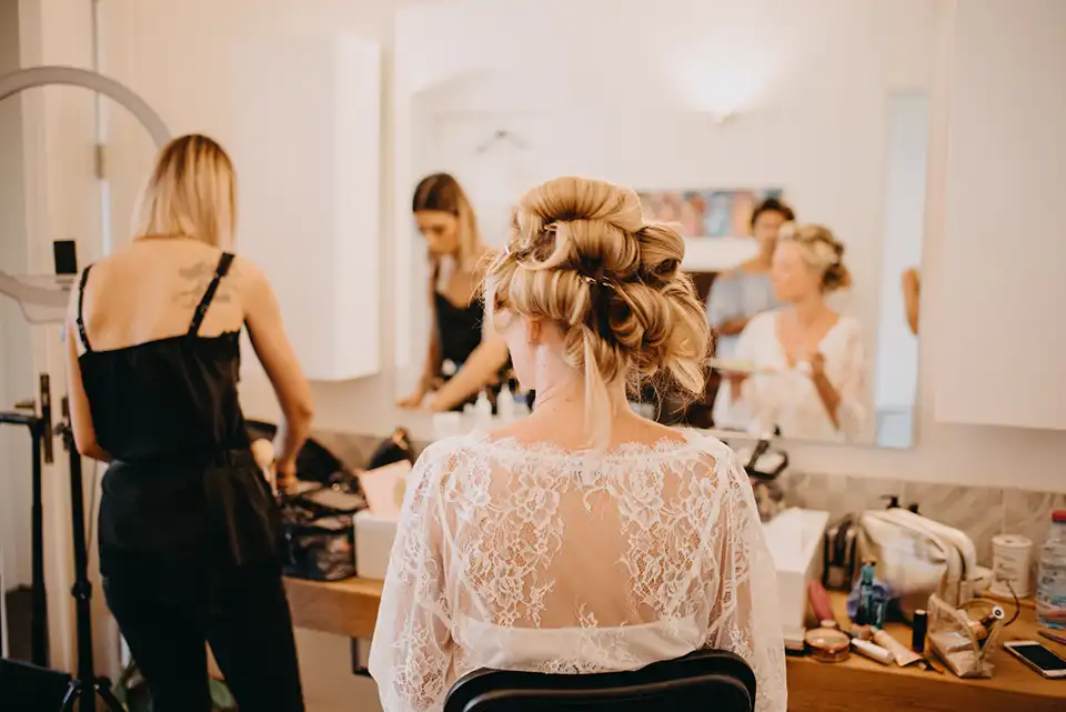 Bride sitting in front of a mirror getting ready