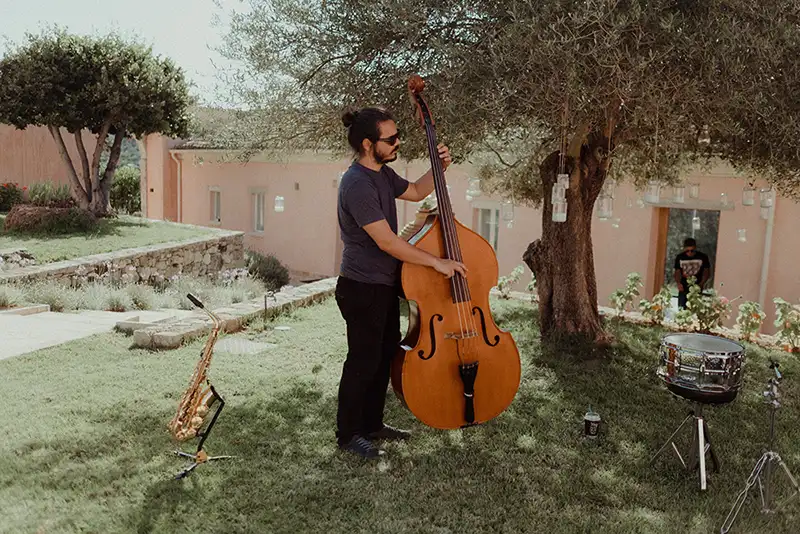 A man playing the Cello in The Courti Estate garden.